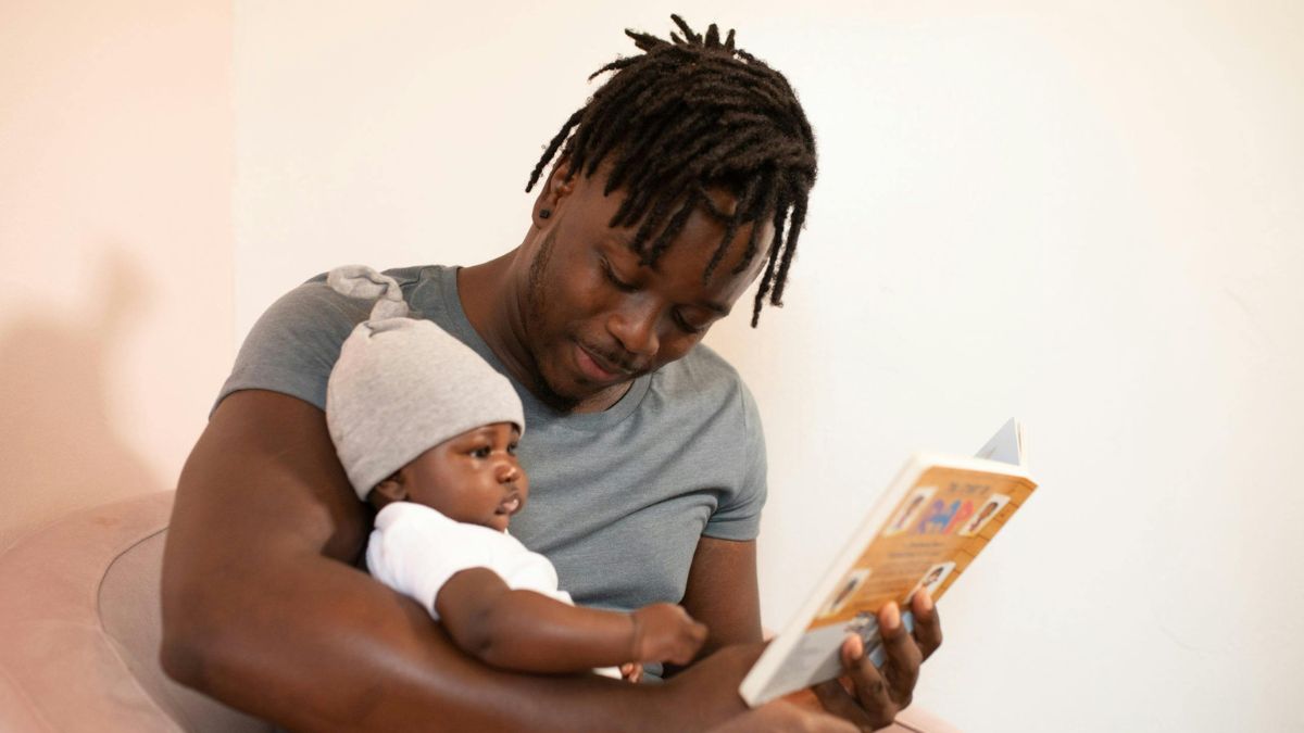 Man reading book with baby